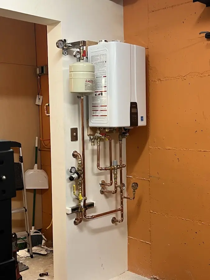Plumbing technician inspecting water heater connections in Suisun City